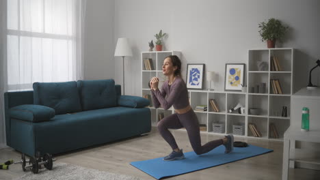 jump-and-squat-during-training-at-home-woman-is-practicing-fitness-at-quarantine-and-lockdown-keeping-fit-and-slender-figure-healthy-lifestyle